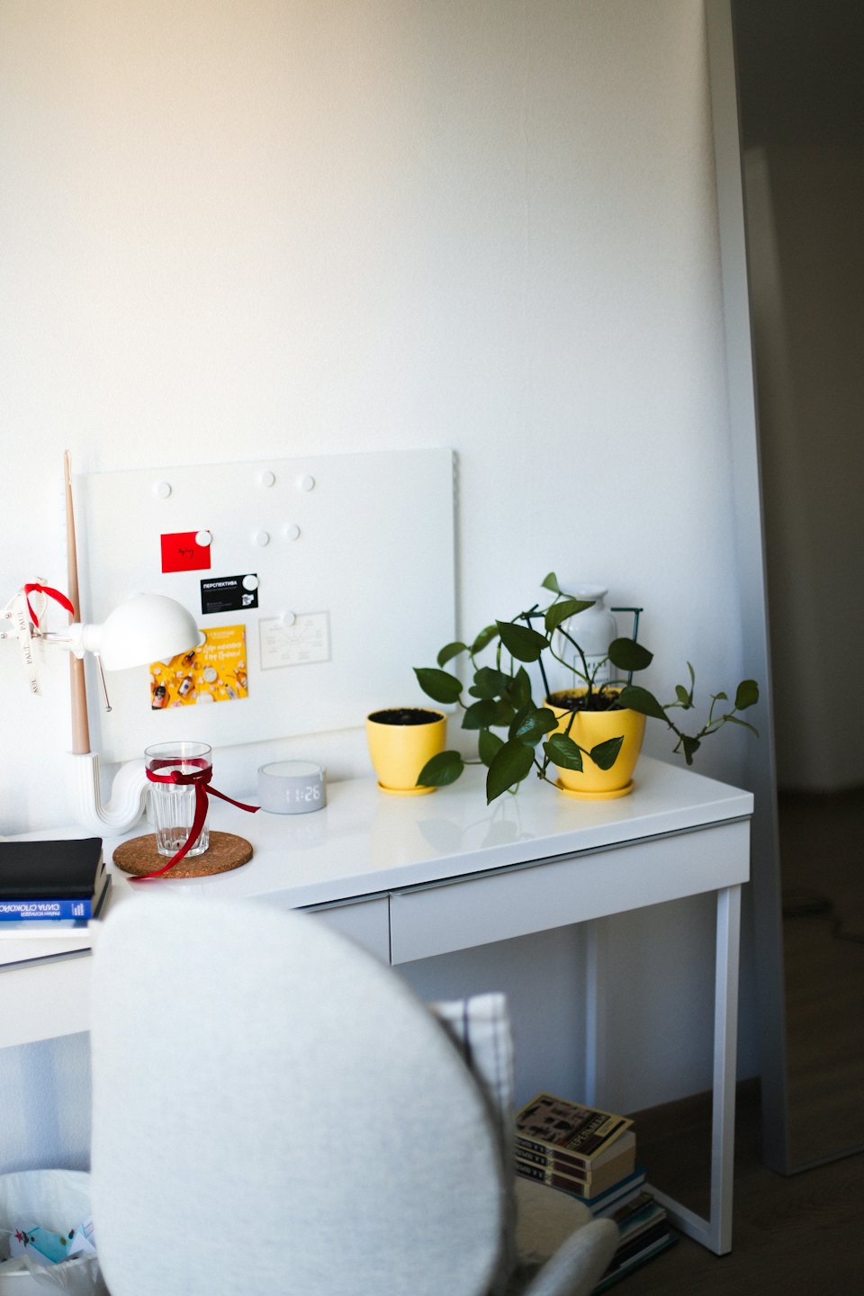 Neatly organized home office desk with plants and notes.